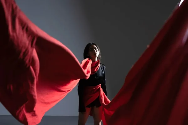 A dancer with a long red costume