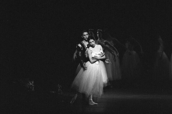 A dancer in long tutu with partner in Giselle