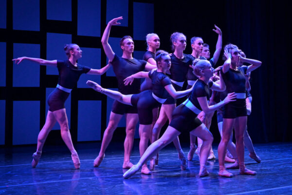 A group of dancers in black costumes
