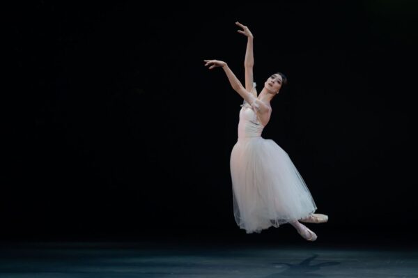 A dancer in long tutu leaps in Giselle