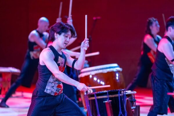 A taiko drummer, drumming.