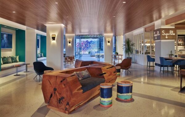 The front lounge at the Viceroy Santa Monica, showing a large log cut-out for a sofa.