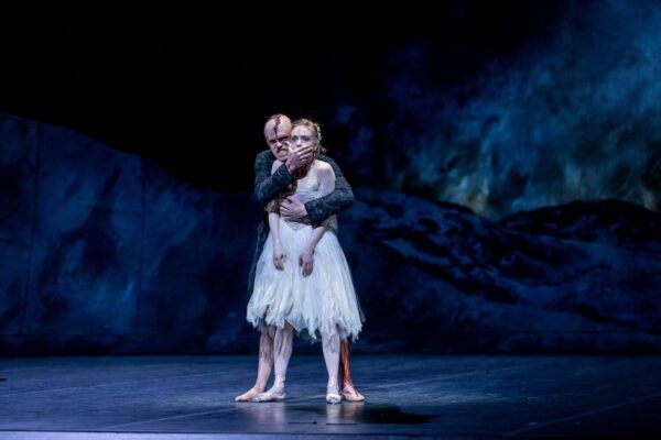 A man puts hand over dancer in front of him