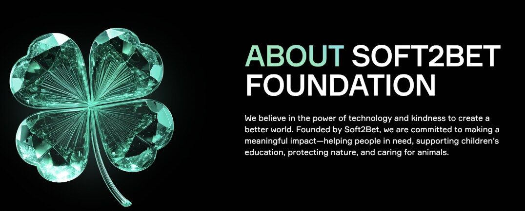 Soft2Bet Foundation promotional banner featuring a crystal green four-leaf clover and mission statement about using technology and kindness to support education, nature, and animal welfare. 