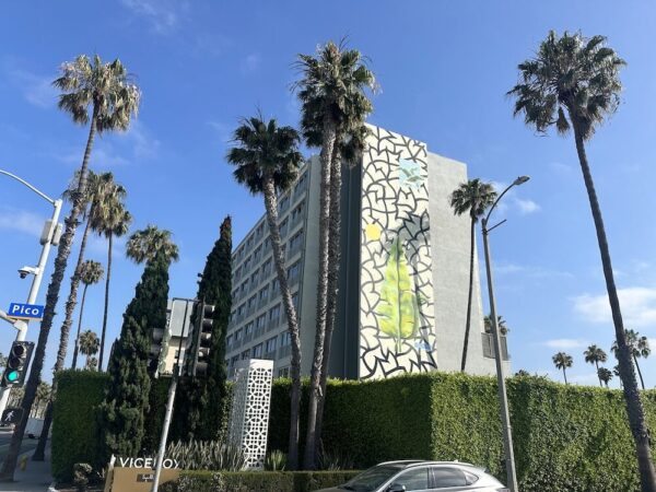 A mural by Spencer Mar Guilburt with its black interconnecting shapes and palm leaves, is on the building's south side.