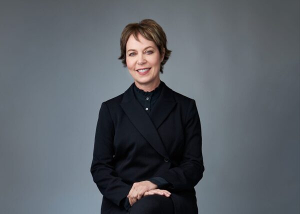 A short-haired woman looks at the camera in Giselle