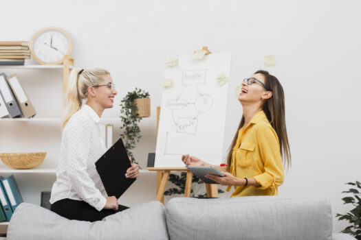 Lateral view smiling women holding a tablet and a clipboard