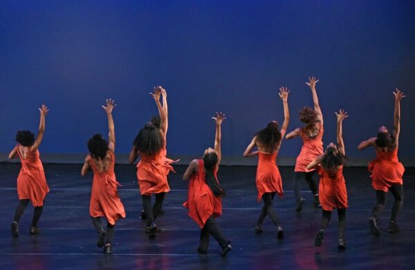 A group of dancers in red