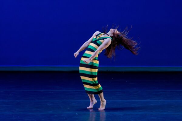 A dancer in green and yellow stripes