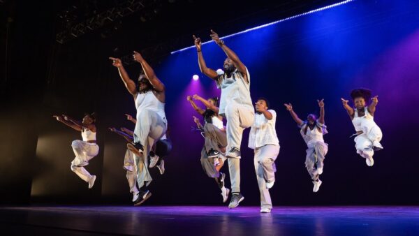 Dancers in white jumping