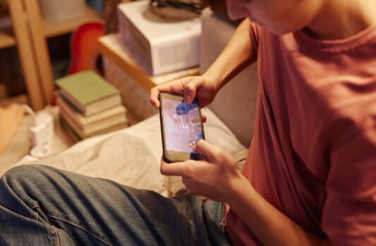 Kid playing with his phone.
