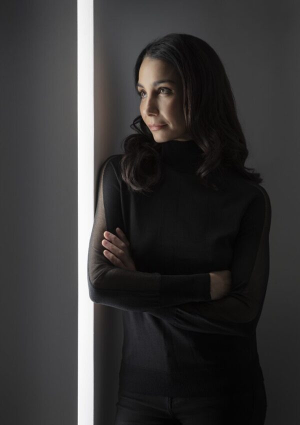 A woman looks off camera