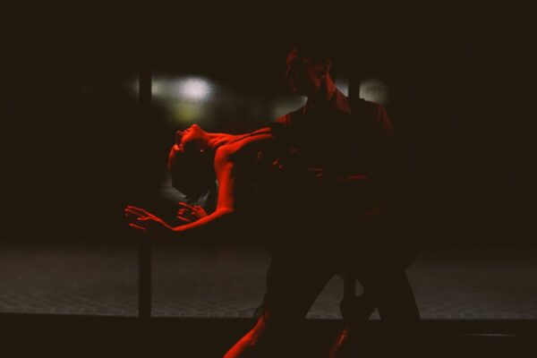Two dancers in a red light
