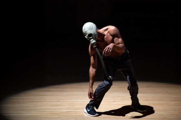 A dancer in a gas mask