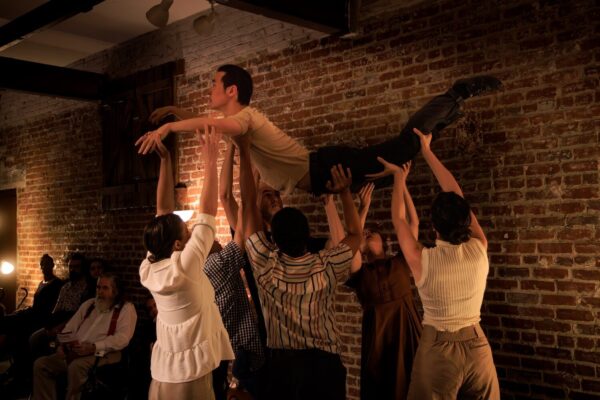 A group of dancers holds another