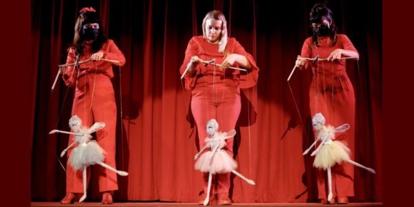 three women operate three marionettes