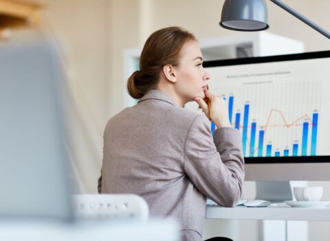 Pensive employee analyzing statistics