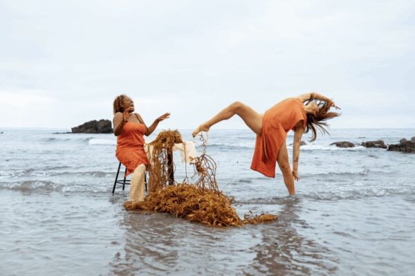 A dancer and a singer in orange