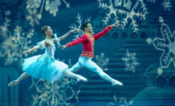 Two dancers leap together