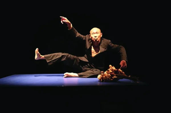 A dancer on the ground looks up