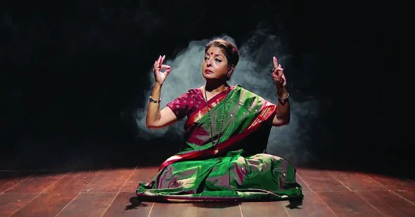 A dancer sits on the floor