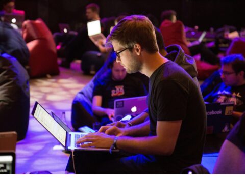 Man on chair in front of laptop