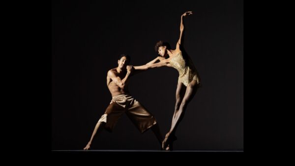 A male dancer holds hand of female dancer
