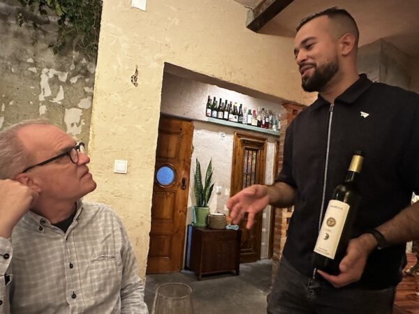 Wine is presented to a diner.