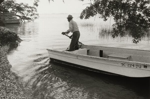 Jeanne Moutoussamy-Ashe (American, born 1951), Jake With His Boat Arriving on Daufuskie’s Shore, Daufuskie Island, South Carolina, 1978, printed 2007, gelatin silver print; National Gallery of Art, Washington, gift of funds from Diana and Mallory Walker, 2024.