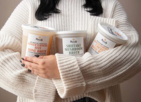 Woman holding plastic containers.