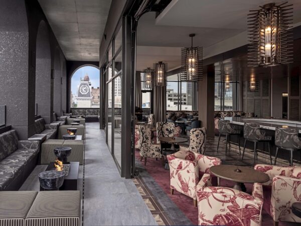 The rooftop bar is flanked by wall windows that open onto the cityscape / Photo courtesy of Bourré Bonne
