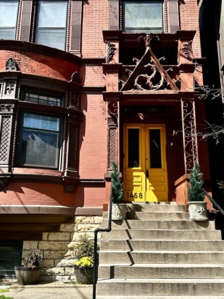 A Victorian mansion with a yellow door. 