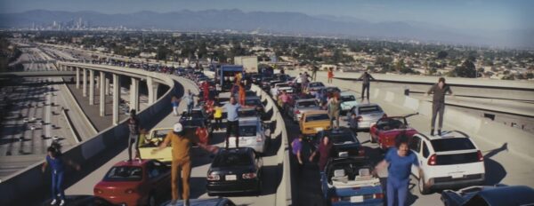 Dancers atop cars on freeway