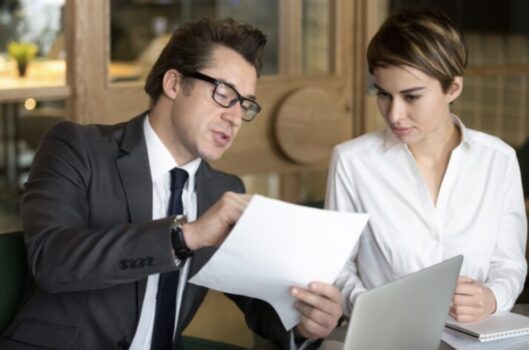 Business people looking at papers.