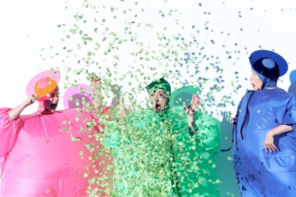 Three figures with confetti. The Seaweed Sisters. Photo by Vuki