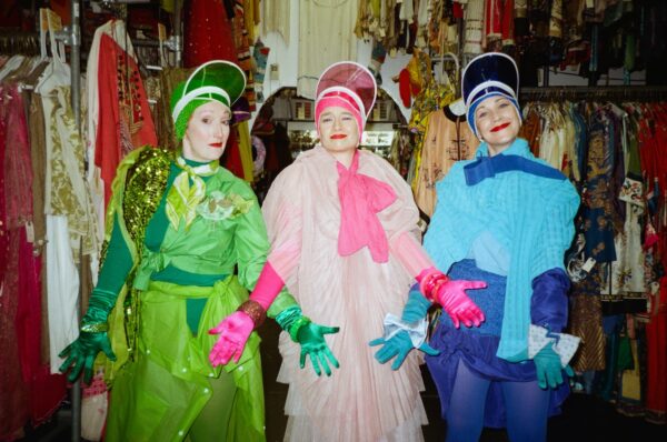 Three ladies in green, pink and blue