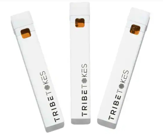 Three slim white branded pen-style devices with amber windows standing upright