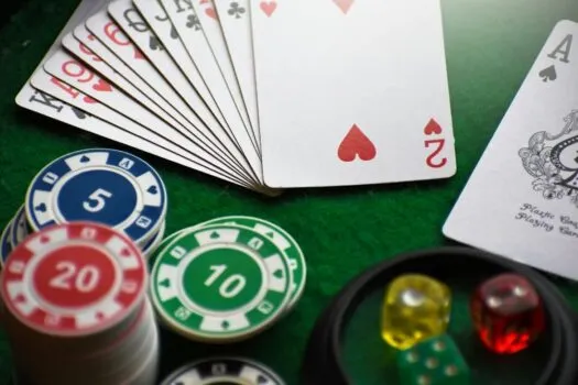 Casino table with cards, chips, and dice.