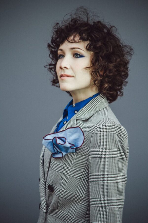 A dark haired woman in a suit