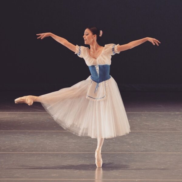 A ballet dancer lifts her leg