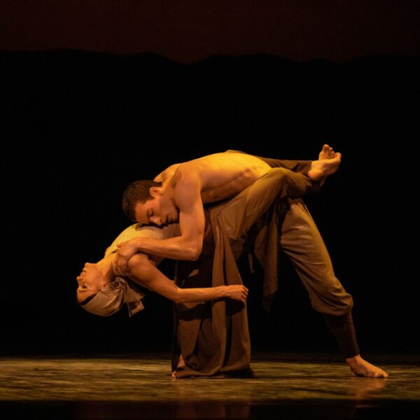 A male dancer bends over a female dancer