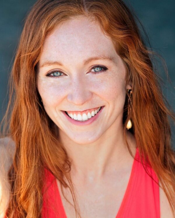 A red headed woman in a red dress
