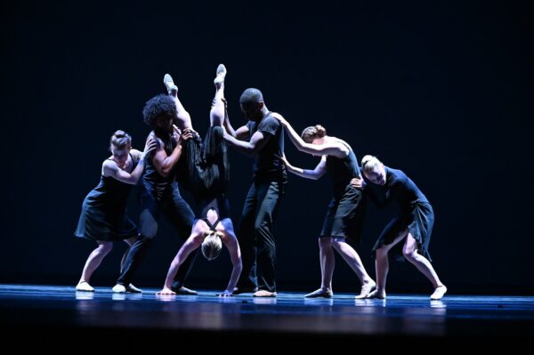A group of dancers in black