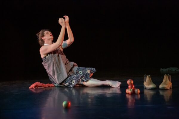 Dancer on floor lifting arms