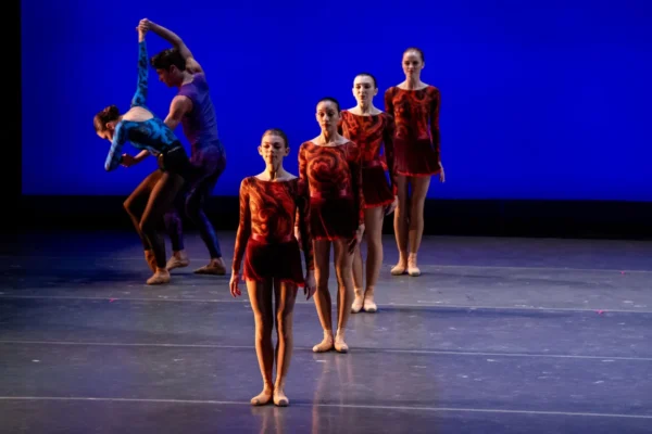 A line of dancers in red