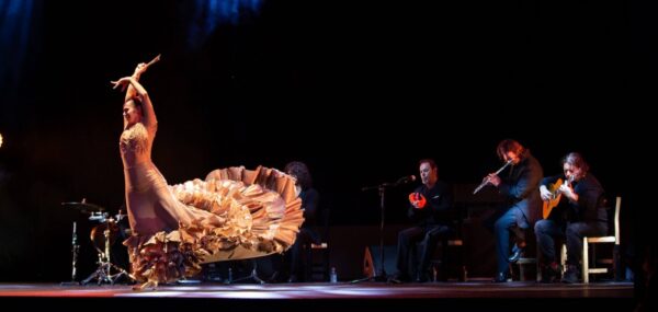 A flamenco dancer with musicians