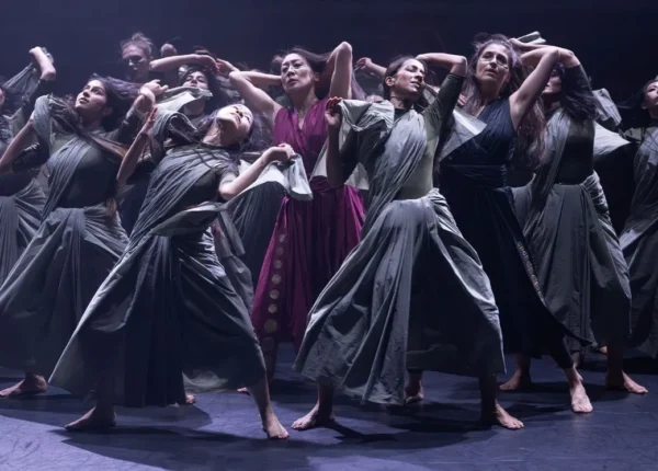 A group surrounds dancer in red