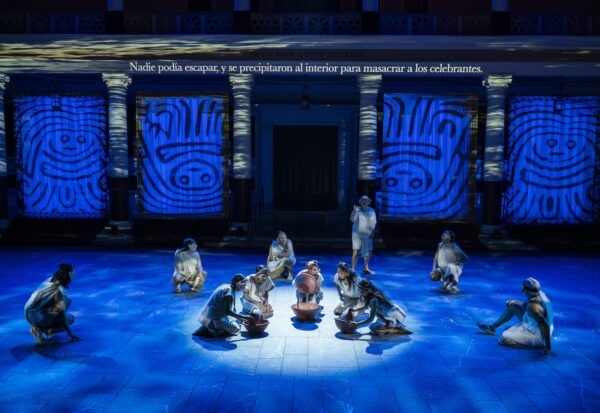 Figures on a blue lit stage