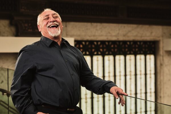 A man in a black shirt laughs