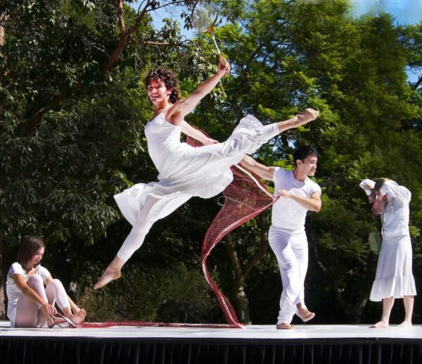 A dancer in white leaps